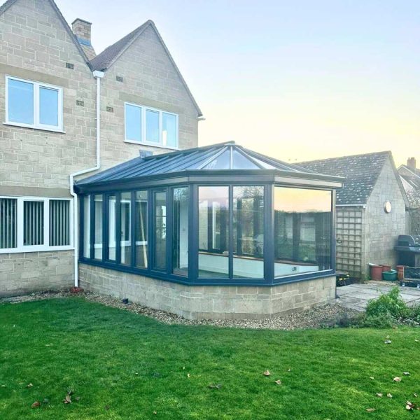 An exterior shot of an aluminium conservatory on a green lawn