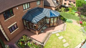 High-angle view of a home featuring an Livinroof hybrid conservatory, combining solid and glazed panels for thermal efficiency and natural light. Perfect for modern living.